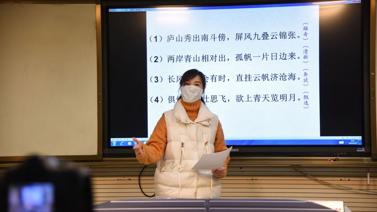 A teacher gives a lecture in front of a camera during an online class at a middle school in Donghai in China's eastern Jiangsu province on February 17, 2020. 