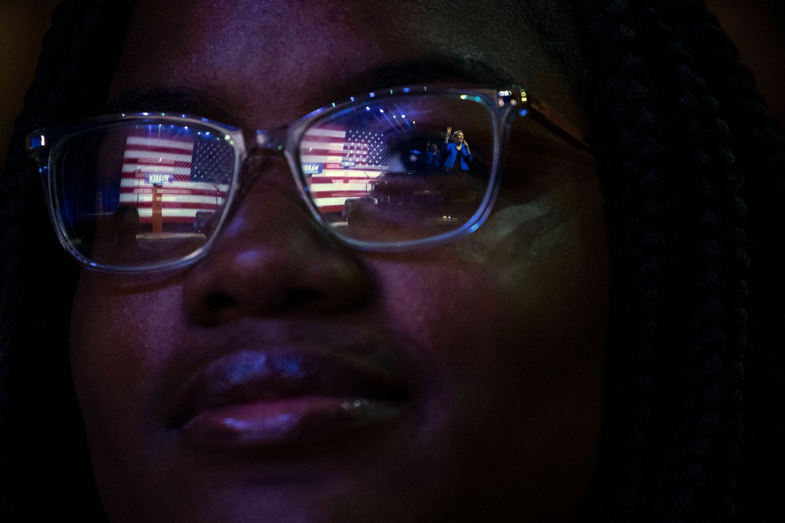 Warren is reflected in a woman's glasses while speaking in Orangeburg on Wednesday.
