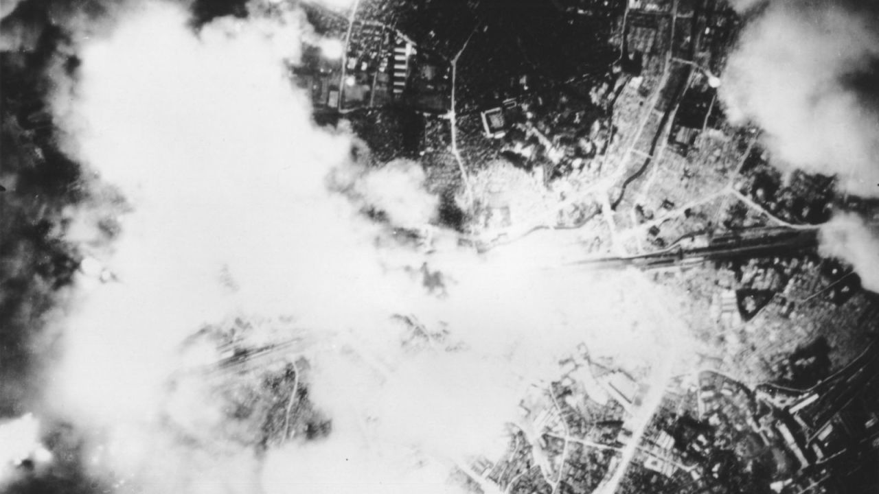 Smoke and fire rise from Tokyo during the US firebomb raid.