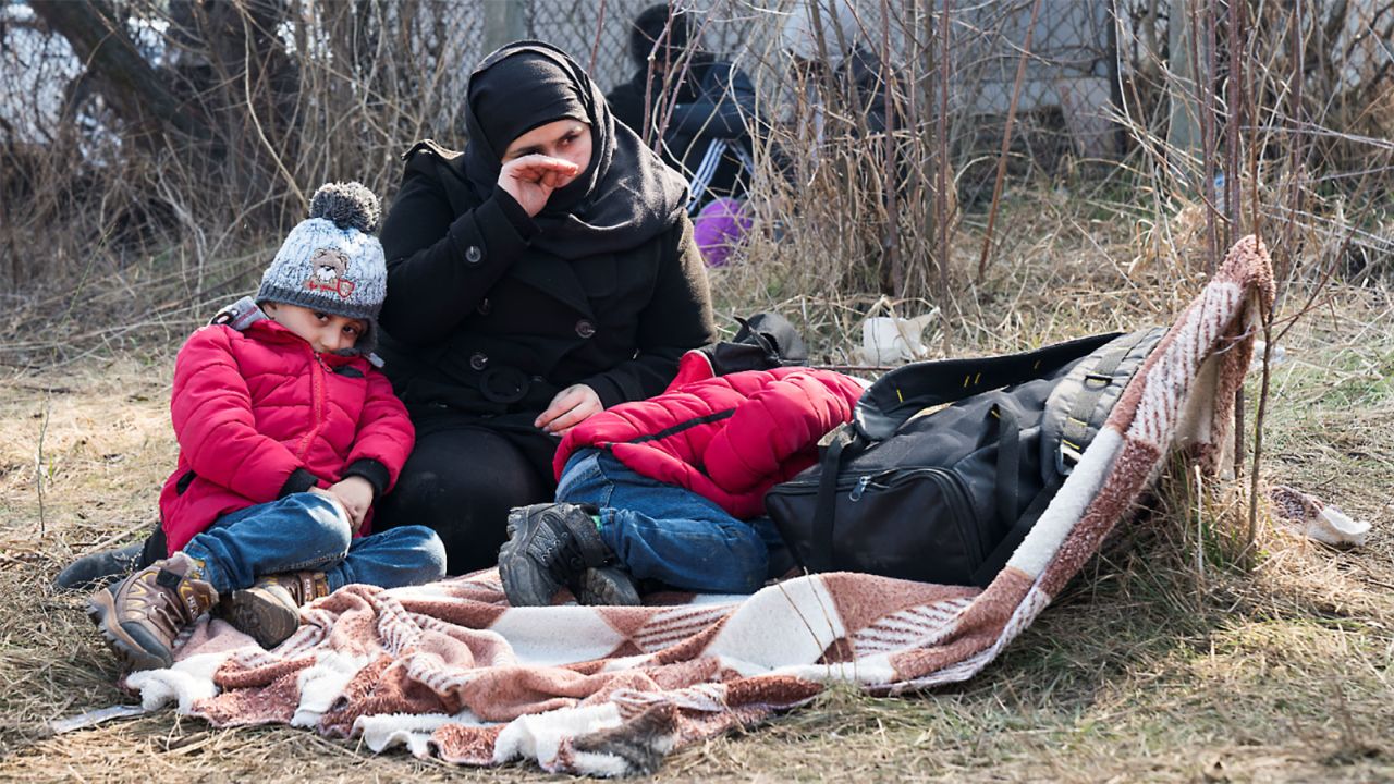 Migrants rest at the Pazarkule Border post between Turkey and Greece.