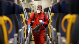 A cleaner sanitizes a wagon on a regional train, at the Garibaldi train station in Milan, Italy, Friday, Feb. 28, 2020. Authorities are taking new measures to sanitize trains and public transportation after the COVID-19 virus outbreak. (AP Photo/Luca Bruno)
