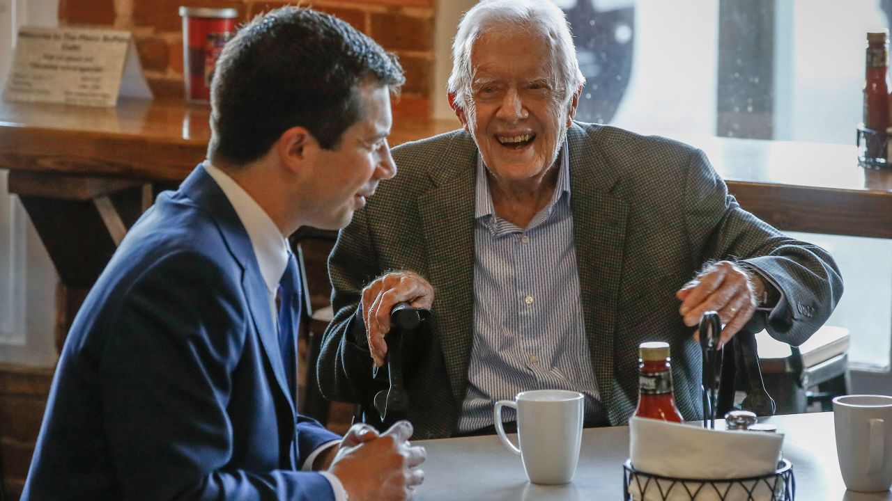 Democratic presidential candidate former South Bend, Indiana, Mayor Pete Buttigieg, left, meets with former President Jimmy Carter, center, at Buffalo Cafe in Plains, Georgia, Sunday, March 1, 2020. 