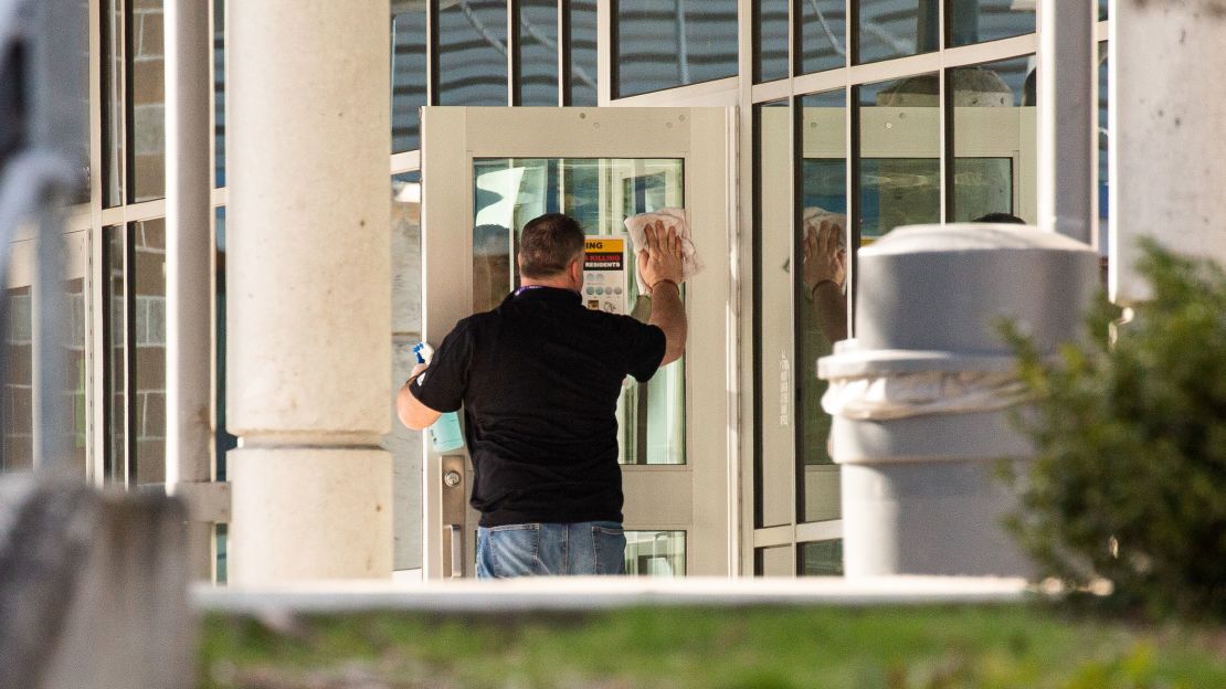 A staff member cleans a door at Bothell High School on February 27, 2020 in Bothell, Washington state.