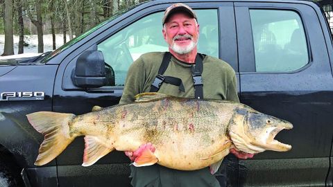 Thomas Knight with the enormous lake trout that broke New Hampshire's 62-year-old state record for the largest lake trout.