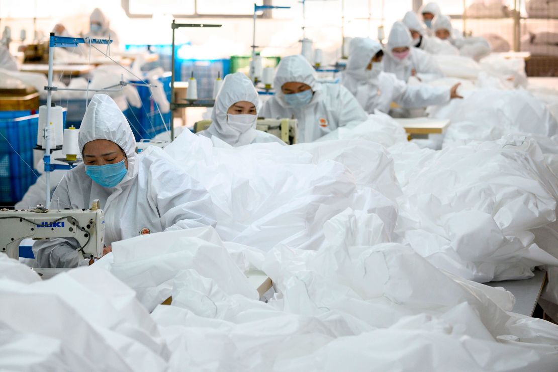 This photo taken on February 28, 2020, shows workers sewing at factory making hazardous material suits to be used in the COVID-19 coronavirus outbreak, at the Zhejiang Ugly Duck Industry garment factory in Wenzhou.