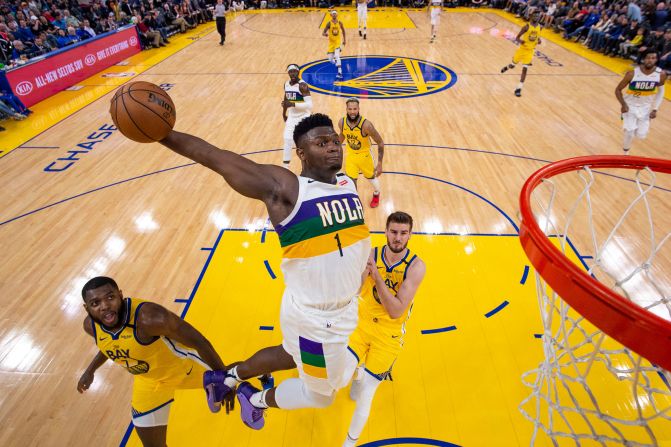 New Orleans Pelicans' Zion Williamson dunks the basketball against Golden State Warriors' Eric Paschall and Dragan Bender during the second half at Chase Center in San Francisco, February 23.