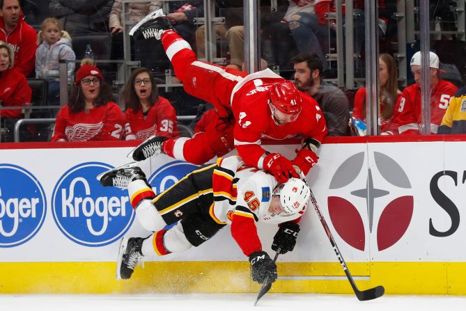 Detroit Red Wings' Luke Glendening and Calgary Flames' Alexander Yelesin collide along the boards in the first period of an NHL hockey game in Detroit on February 23.