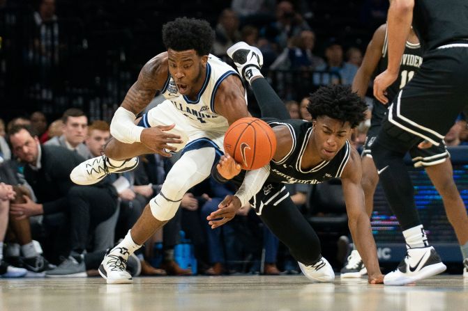 Villanova Wildcats' Saddiq Bey and Providence Friars' David Duke dive for the ball during a game in Philadelphia on February 29.