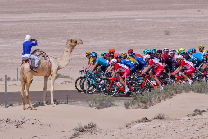 The pack rides past an onlooker during the third stage of the UAE Cycling Tour from al-Maroom to Jebel Hafeet, on February 24.