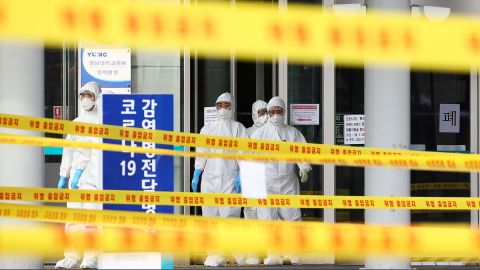 Medical staff stand outside a hospital in Daegu, South Korea, on March 1.