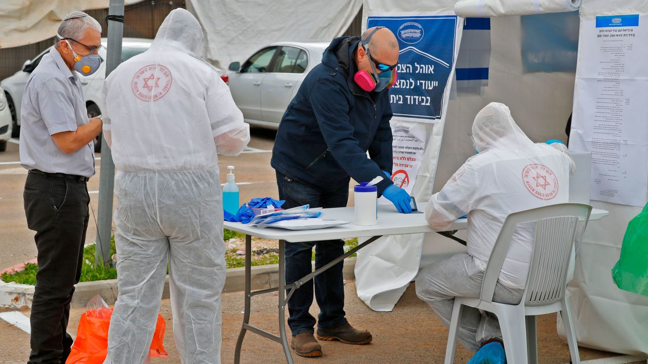 Israelis vote at a polling booth specially erected for the 5,600 Israelis under self-quarantine, many of whom visited countries with cases of the coronavirus.