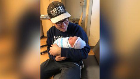 Dane Demchak holds his baby daughter on February 29, 2020.