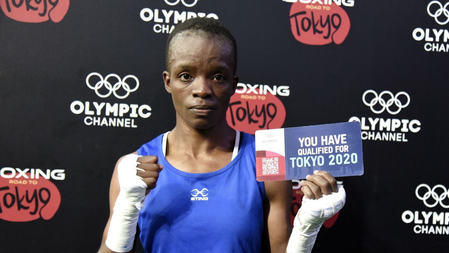 Kenya's Christine Ongare holds her qualifying ticket after her victory against Uganda's Catherine Nanziri during the  Africa Boxing Olympic Qualification tournament in Dakar, Senegal on Saturday.