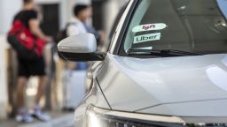 Lyft Inc. and Uber Technologies Inc. signage are displayed on the windshield of a vehicle at Los Angeles International Airport (LAX) in Los Angeles, California, U.S., on Wednesday, Sept. 11, 2019. Uber Technologies Inc. drivers in California sued the company for violating a new state law they say is specifically designed to end Uber's practice of classifying the drivers as independent contractors, rather than employees. Photographer: Allison Zaucha/Bloomberg via Getty Images