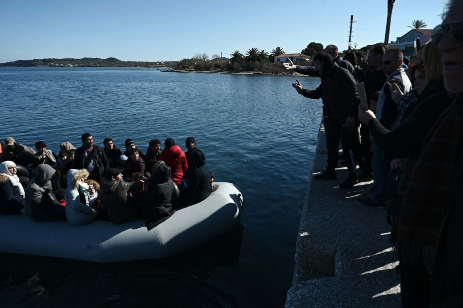 An inflatable boat carrying migrants is met by residents attempting to prevent them from landing on the Greek island of Lesbos on Sunday, March 1.