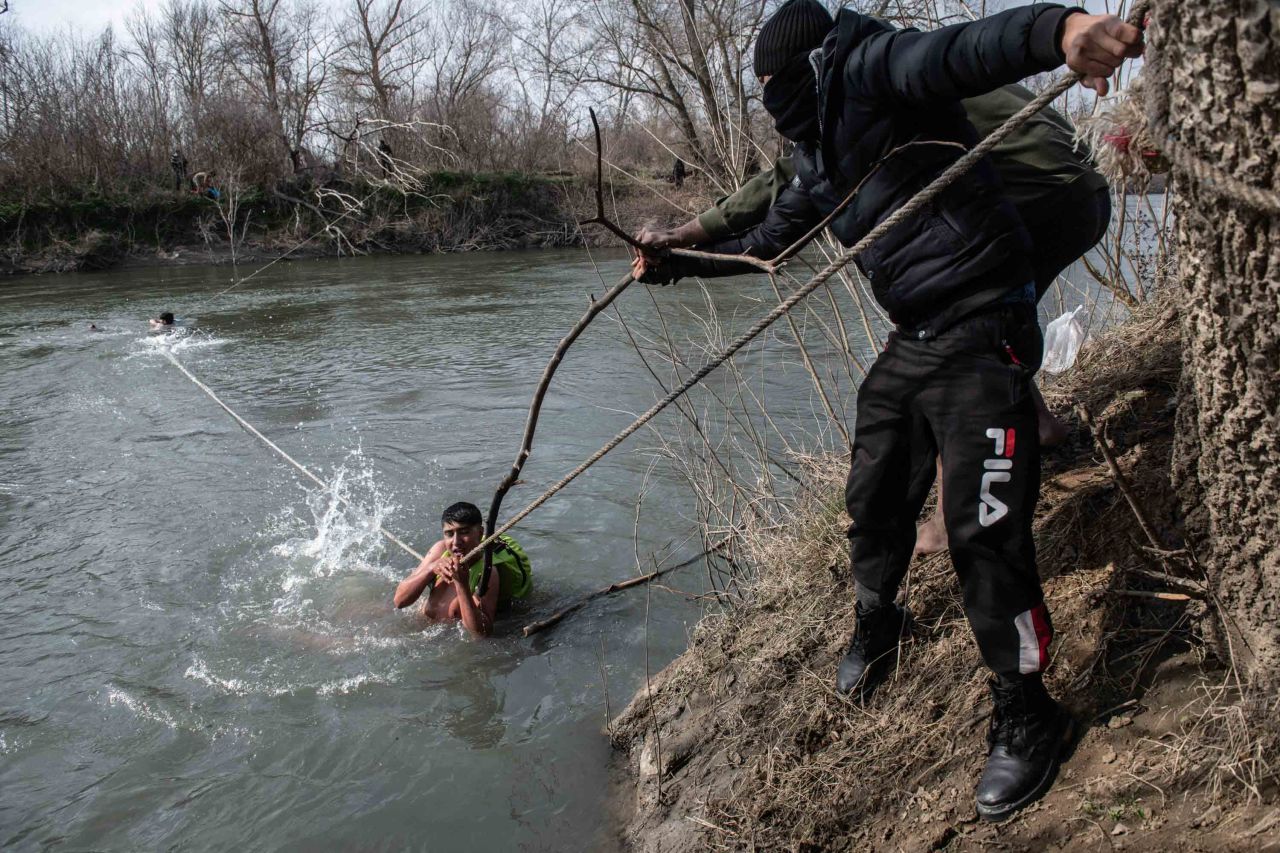 Migrants are rescued from the Evros river after trying to cross from Turkey into Greece on March 1.