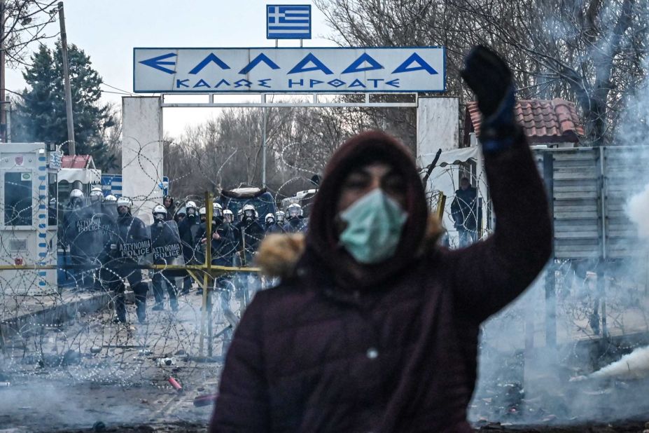 A migrant gestures as Greek police officers use tear gas at the Pazarkule crossing on February 29.