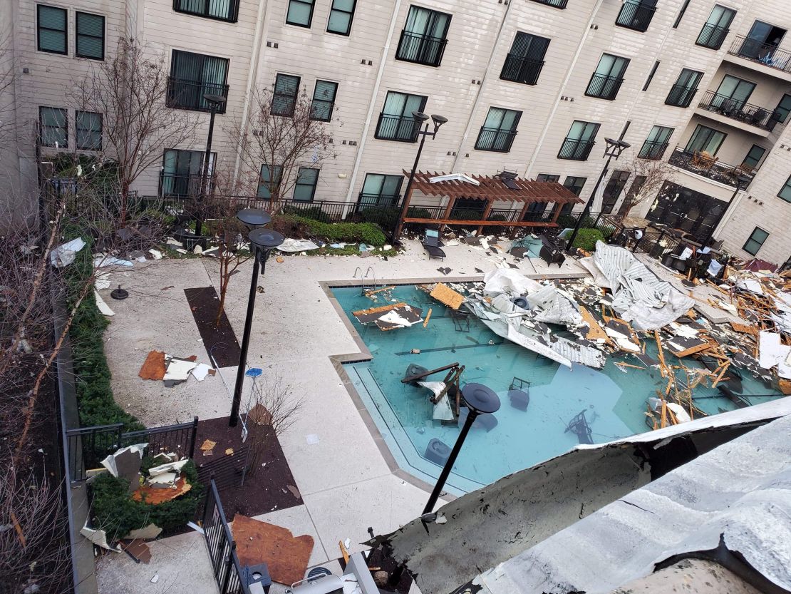 Storm debris is strewn across an apartment swimming pool in the Germantown area of Nashville.