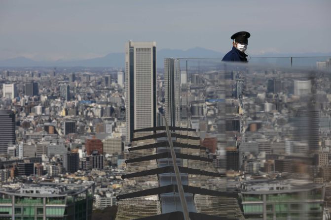 A security guard stands on the Shibuya Sky observation deck in Tokyo on March 3, 2020.
