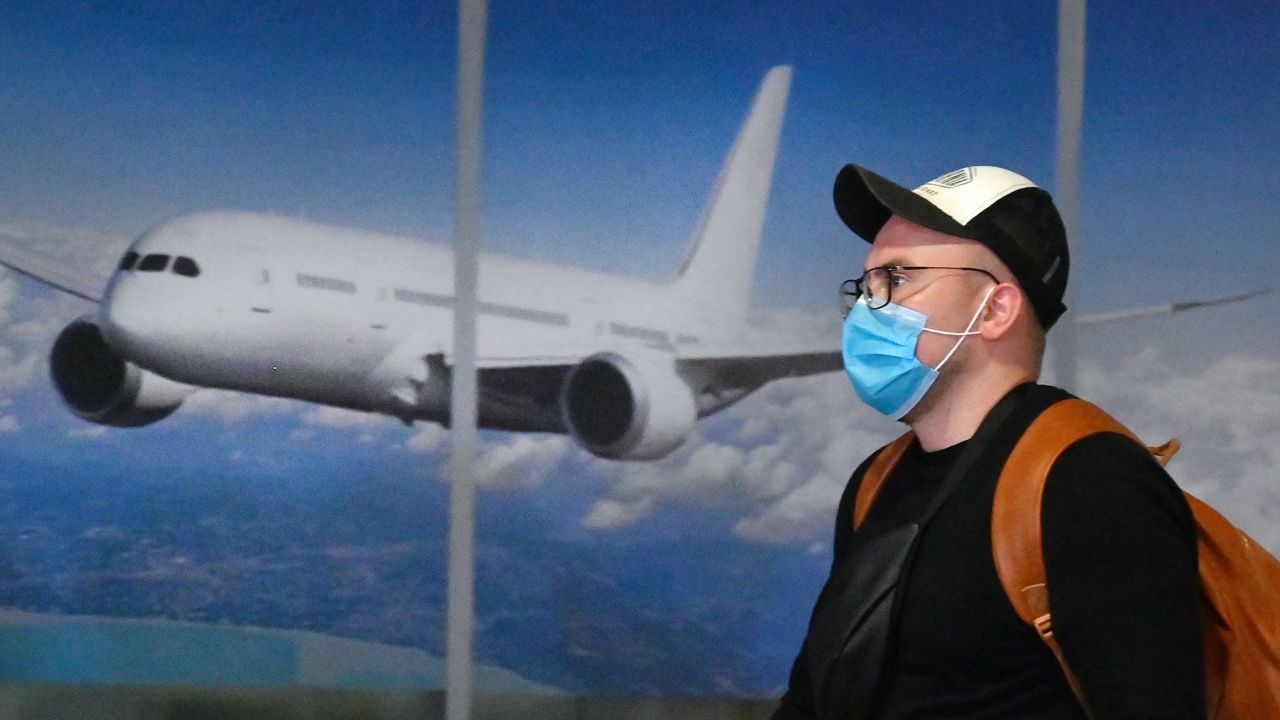 On January 20, a masked traveler arrives in Kiev after flying in from China. 
