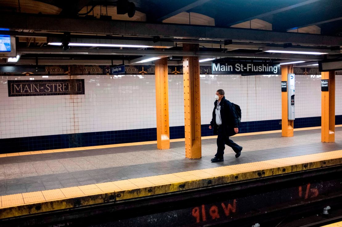 A man wears a face mask on a subway plattform in Flushing, Queens.  