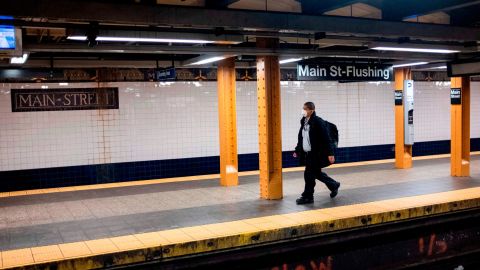 A man wears a face mask on a subway plattform in Flushing, Queens.  