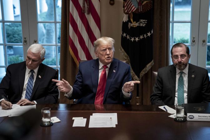 US President Donald Trump, flanked by Vice President Mike Pence, left, and Health and Human Services Secretary Alex Azar, speaks during a meeting with pharmaceutical executives and the White House coronavirus task force on March 2. Throughout <a href="index.php?page=&url=https%3A%2F%2Fwww.cnn.com%2F2020%2F03%2F02%2Fpolitics%2Fdonald-trump-coronavirus-vaccine-push-back%2Findex.html" target="_blank">the meeting,</a> Trump was hyperfocused on pressing industry leaders in the room for a timeline for a coronavirus vaccine and treatment. But experts at the table -- from the administration and the pharmaceutical industry -- repeatedly emphasized that a vaccine can't be rushed to market before it's been declared safe for the public.