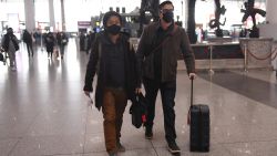 Wall Street Journal reporters Josh Chin (R) and Philip Wen walk through Beijing Capital Airport before their departure on February 24, 2020. - Two Wall Street Journal reporters left China on February 24 after being expelled over a controversial headline in an op-ed that angered Beijing. Three reporters were ordered out of the country last week over what Beijing deemed a racist headline that the journalists were not involved in writing -- marking one of the harshest moves against foreign media in years. (Photo by GREG BAKER / AFP) (Photo by GREG BAKER/AFP via Getty Images)