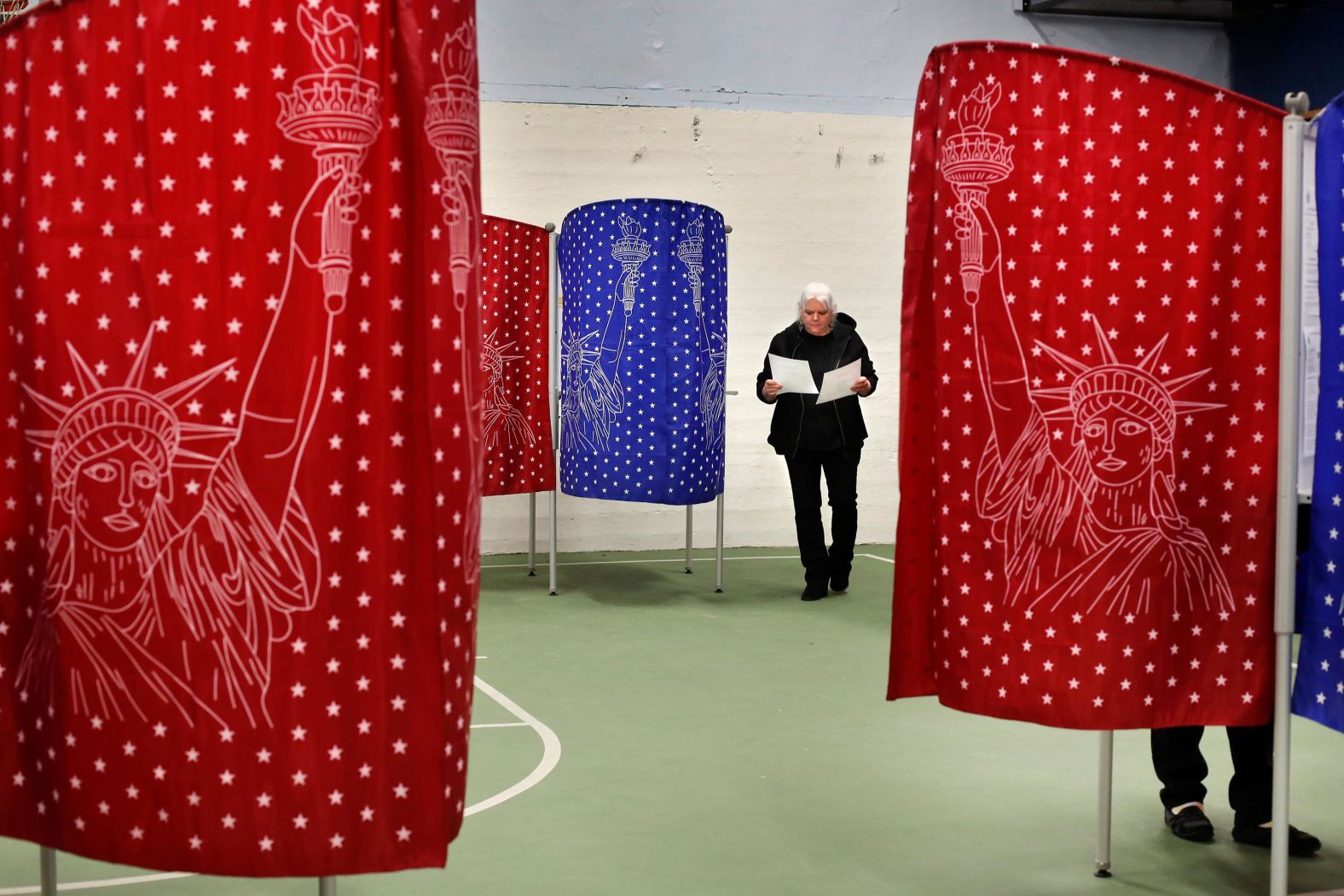 Louise Wilcox checks her ballots after coming out of a booth in Mechanic Falls, Maine.