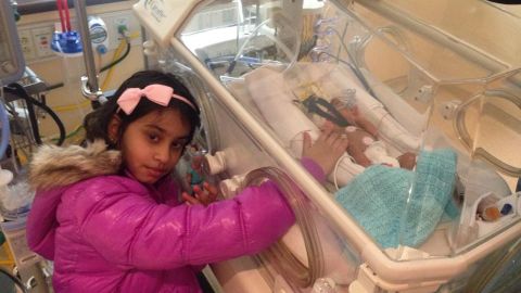Eight-year-old Anoushka Talwar visits her brother Shiv in the NICU after his premature birth. 