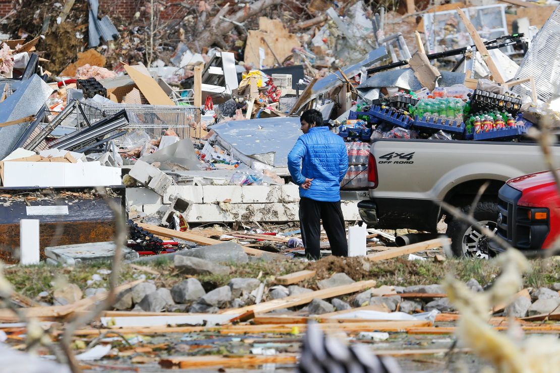 A man searches for items he can salvage from his store Tuesday near Cookeville.
