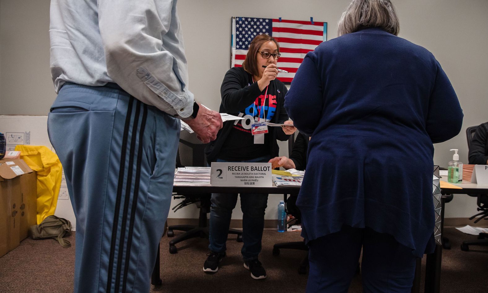 Volunteer Maria Hernandez assists voters at a polling place in San Diego.