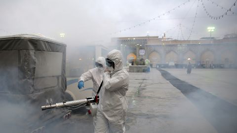 Members of the medical team spray disinfectant to sanitize outdoor place of Imam Reza's holy shrine in Mashhad, Iran on February 27.