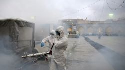 Members of the medical team spray disinfectant to sanitize outdoor place of Imam Reza's holy shrine, following the coronavirus outbreak, in Mashhad, Iran February 27, 2020. Picture taken February 27, 2020. WANA (West Asia News Agency) via REUTERS ATTENTION EDITORS - THIS PICTURE WAS PROVIDED BY A THIRD PARTY