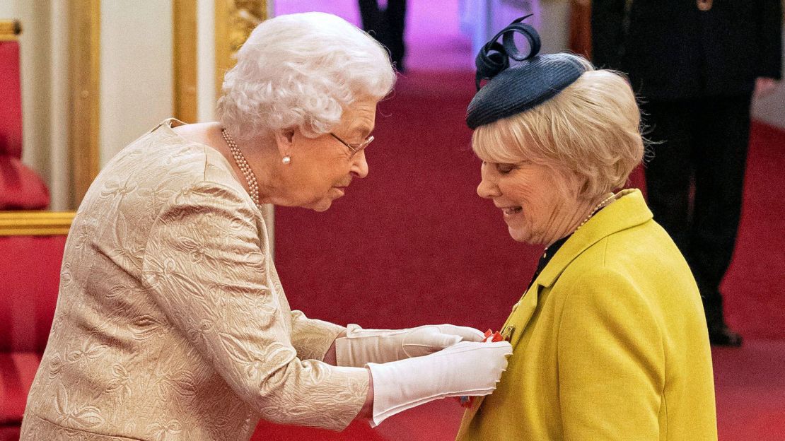 Queen Elizabeth wears gloves during an investiture ceremony at Buckingham Palace in London on Tuesday. 