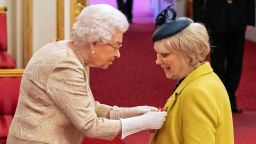 Britain's Queen Elizabeth wears gloves as she awards the CBE (Commander of the Order of the British Empire) to Anne Craig, known professionally as actress Wendy Craig, during an investiture ceremony at Buckingham Palace in London, Tuesday March 3, 2020. Buckingham Palace declined to confirm whether the Queen was taking the precaution because of the coronavirus outbreak. (Dominic Lipinski/PA via AP)