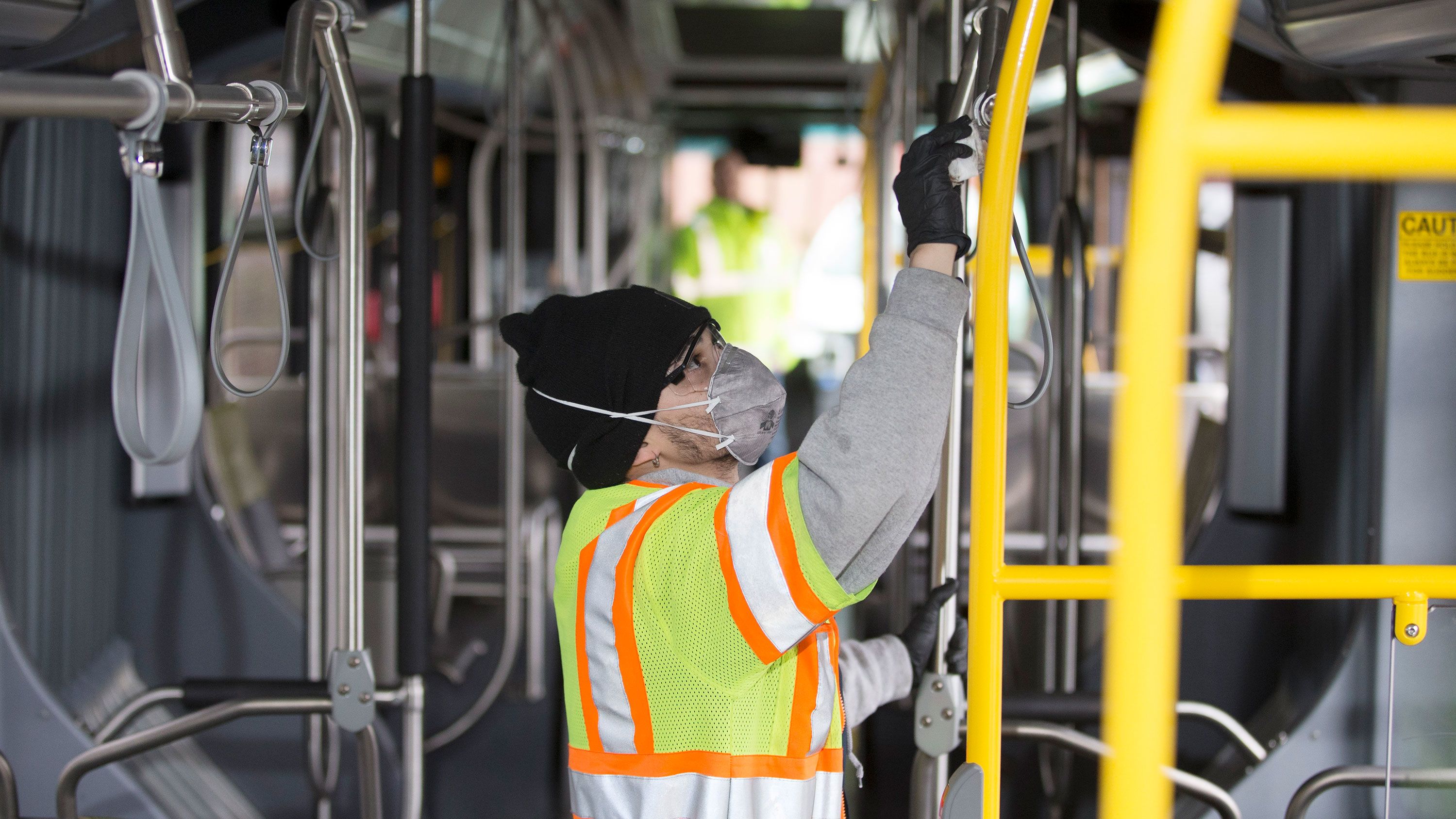 A Seattle transit worker deep cleans a bus.