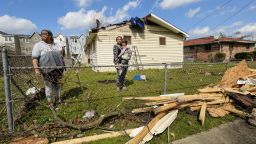 Demetrius Wide, Dominique Hammond and her daughter Analise Hammond are seen outside their home in North Nashville following devastating tornadoes.