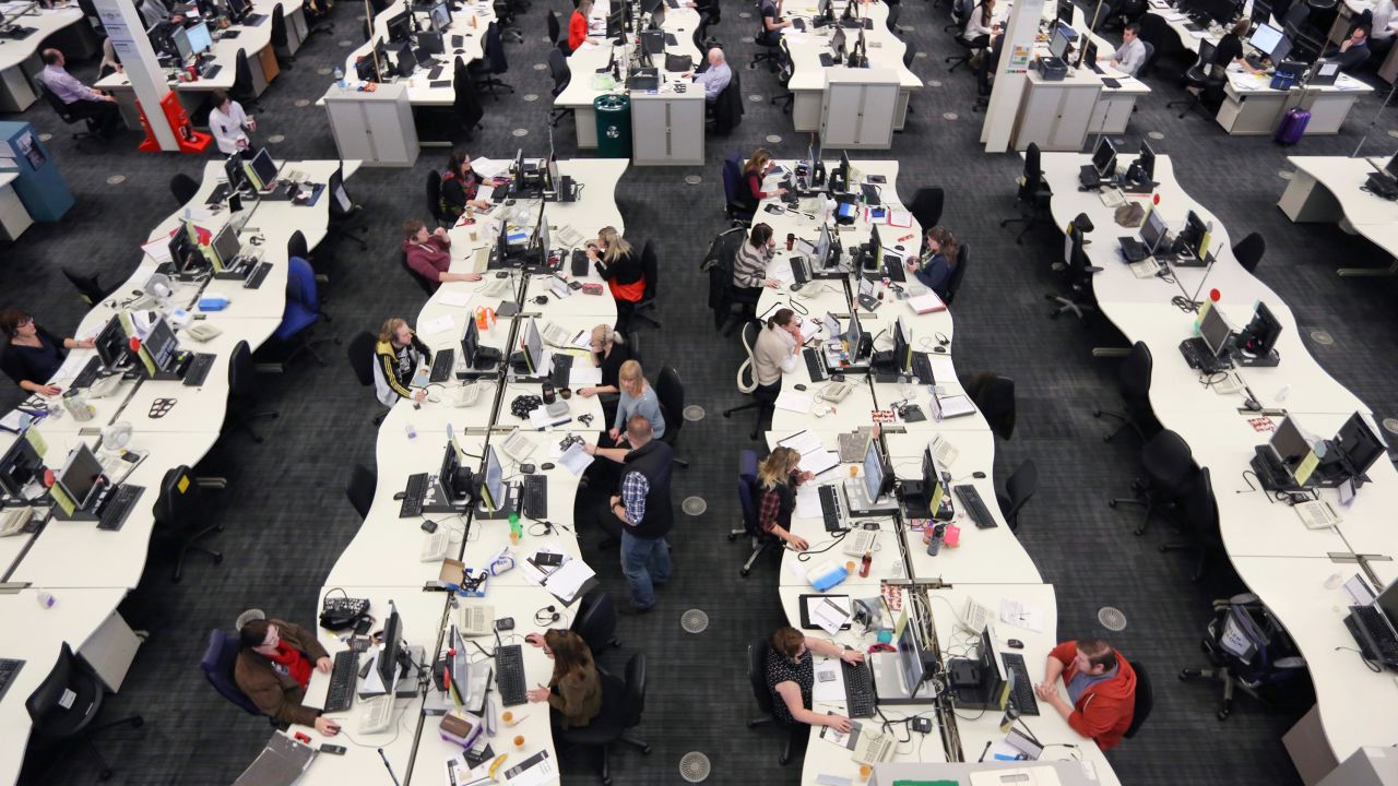 Customer service representatives work inside a call center at First Direct bank, a unit of HSBC.
