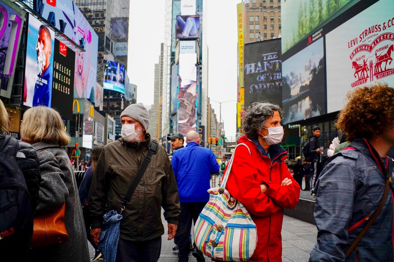 People wear face masks in New York's Times Square on March 3. New York reported its first case of coronavirus two days earlier. 