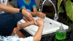 children adult hand washing STOCK