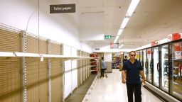 Shelves are empty of toilet rolls in a supermarket in Sydney on March 4, 2020. - Australia's biggest supermarket announced a limit on hand sanitisers and toilet paper purchases after the global spread of coronavirus sparked a spate of panic buying Down Under. 