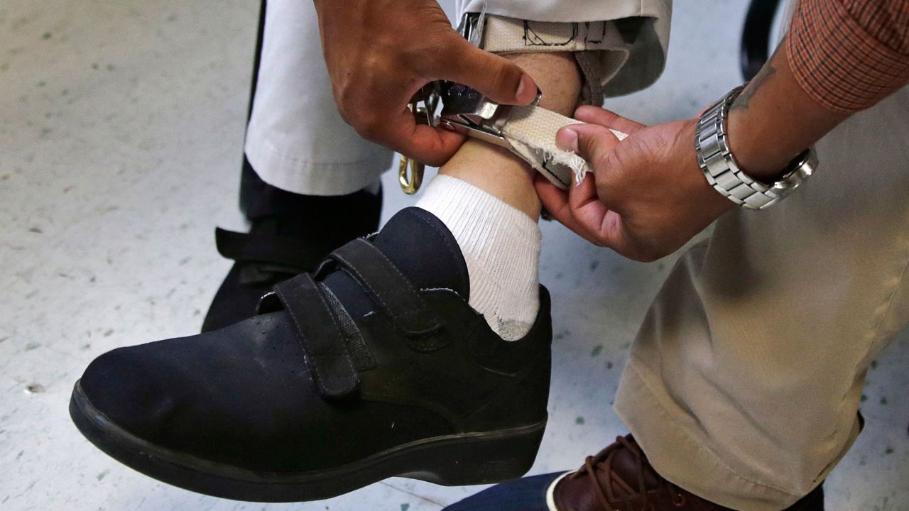 In this August 13, 2014 photo, a therapist checks the ankle strap of an electrical shocking device on a student at the Judge Rotenberg Educational Center in Canton, Massachusetts. The FDA announced a ban on such devices on Wednesday.