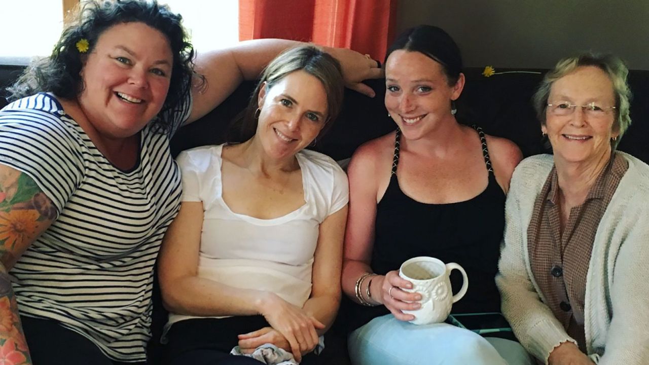 Madelyn Linsenmeir holds a mug as she poses in 2016 with her sisters, Maura O'Neill (far left), Kate O'Neill, and her mother, Maureen Linsenmeir (far right).