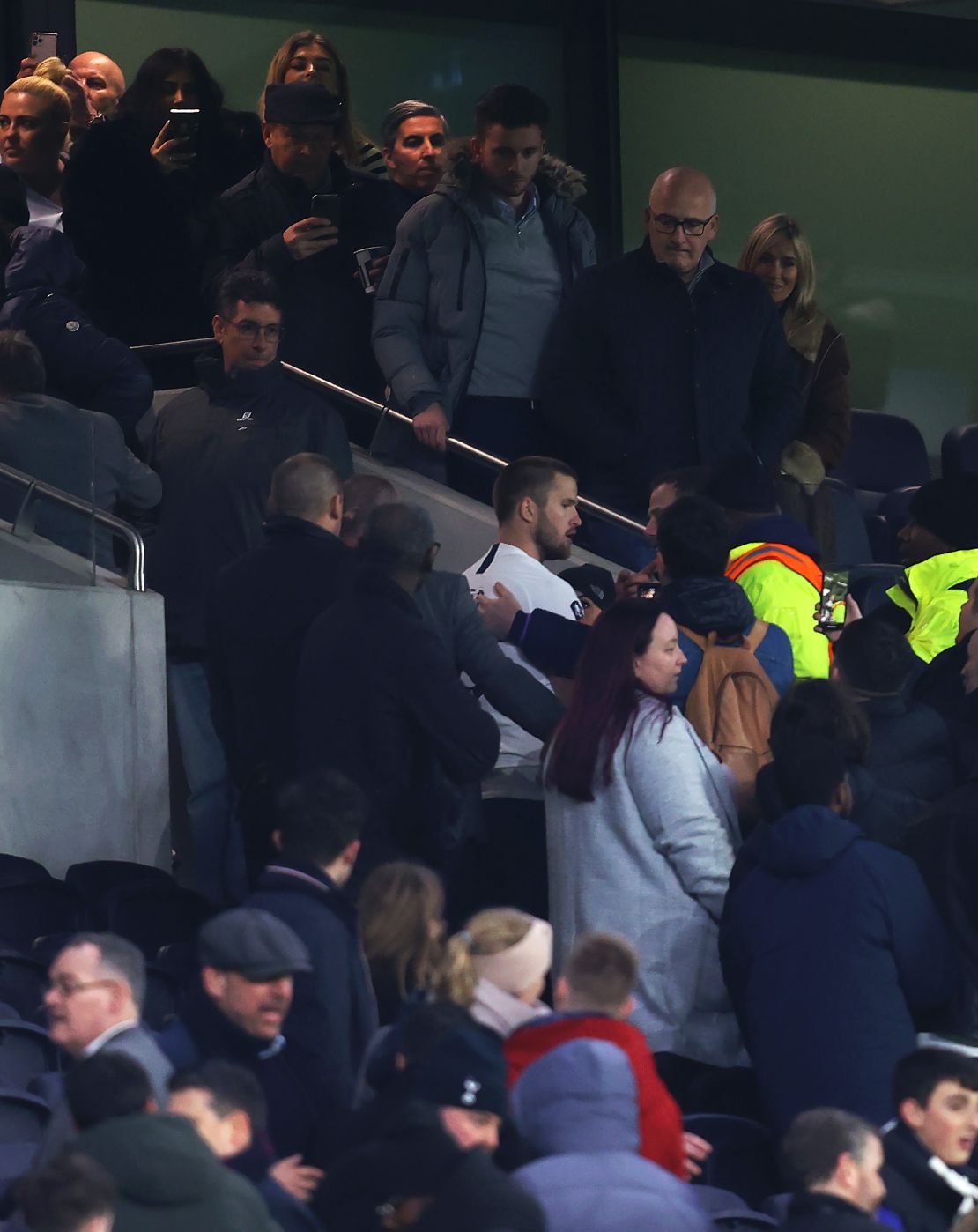 Eric Dier is led away by security after confronting a Tottenham fan following his side's FA Cup defeat. 