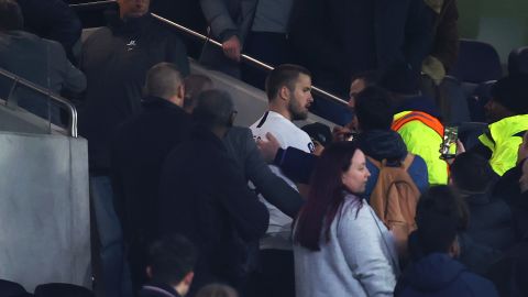 Eric Dier is led away by security after confronting a Tottenham fan following his side's FA Cup defeat.