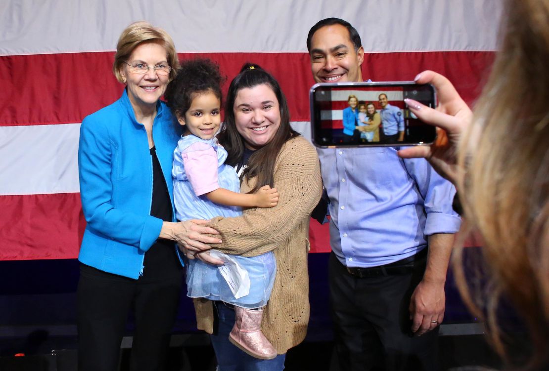 Senator Elizabeth Warren and Julian Castro pose for selfies with her followers during a rally on January 7, 2020 in New York City. 