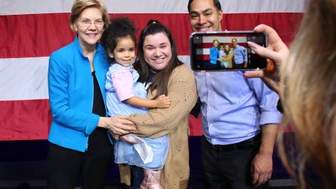 Senator Elizabeth Warren and Julian Castro pose for selfies with her followers during a rally on January 7, 2020 in New York City.