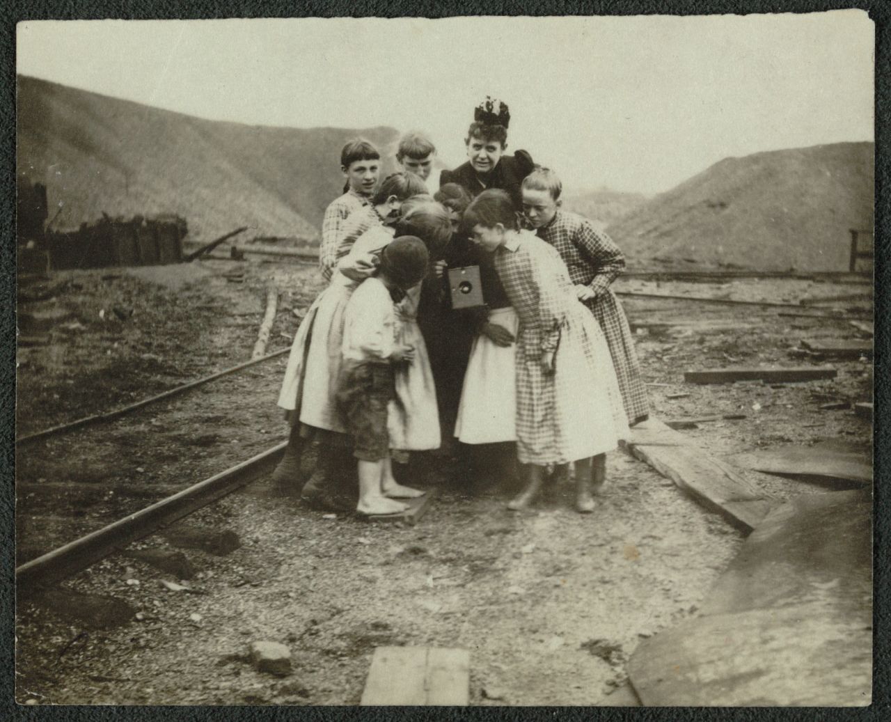 Frances Benjamin Johnston is surrounded by children looking at her camera. Johnston was one of the first-ever female photojournalists, working for the Bain News Service that was founded in New York City in 1898. Her career spanned 60 years and included working in the White House for several administrations. She is also known for her photos of architecture, including historic buildings in the South.