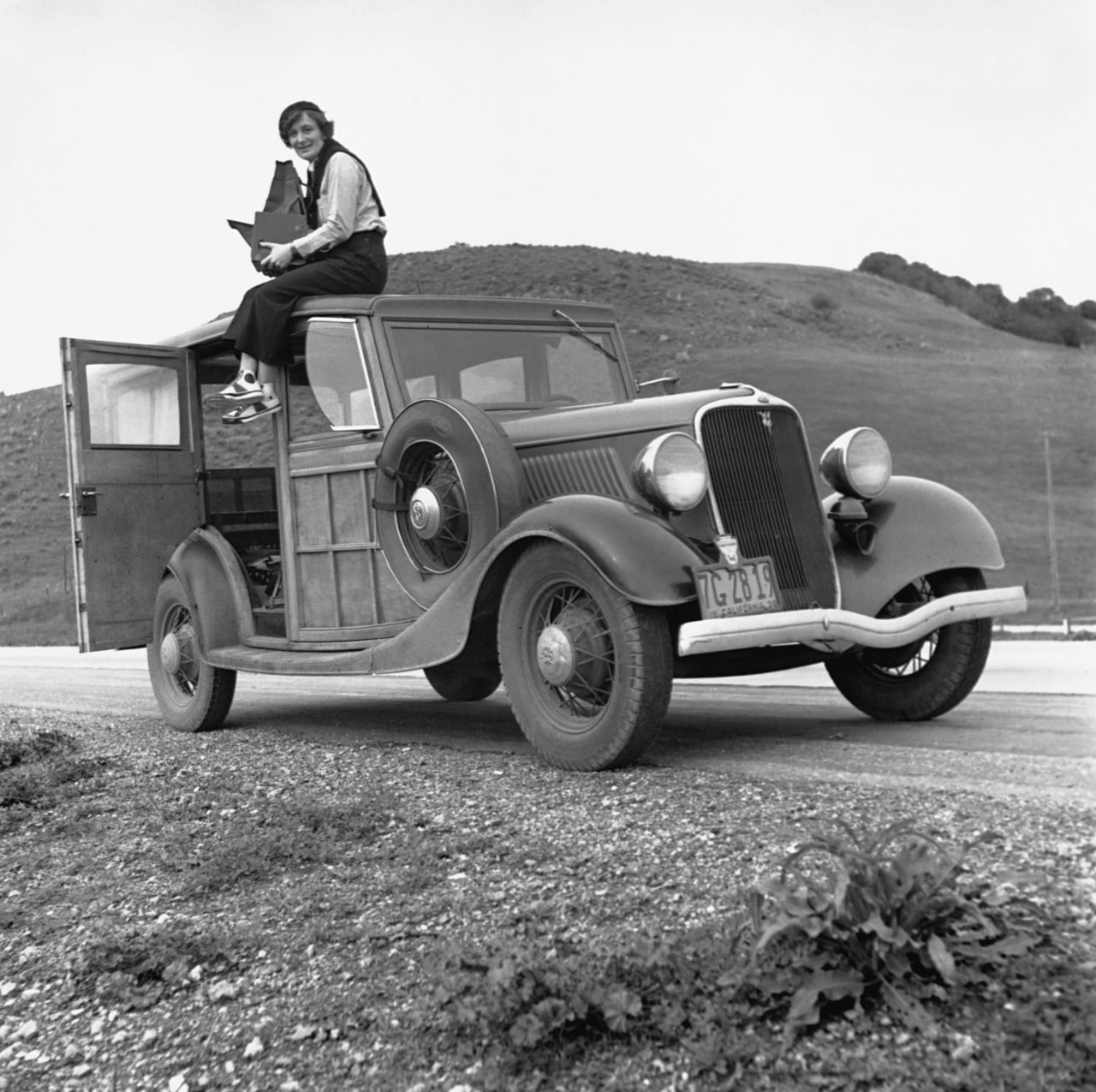 Dorothea Lange holds her camera on the roof of a car in the 1930s. She is famous for her photos of people who were hit hard by the Great Depression. "Migrant Mother," Lange's photo of laborer Florence Owens Thompson, is one of the era's most iconic shots. At the time, Lange was working as a photographer for the Resettlement Administration, a government agency looking to raise public awareness about struggling farmers.